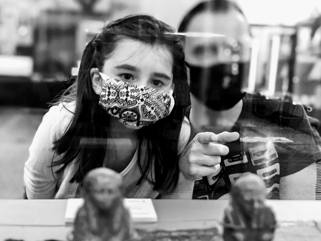 Father and Daughter looking at a museum display case