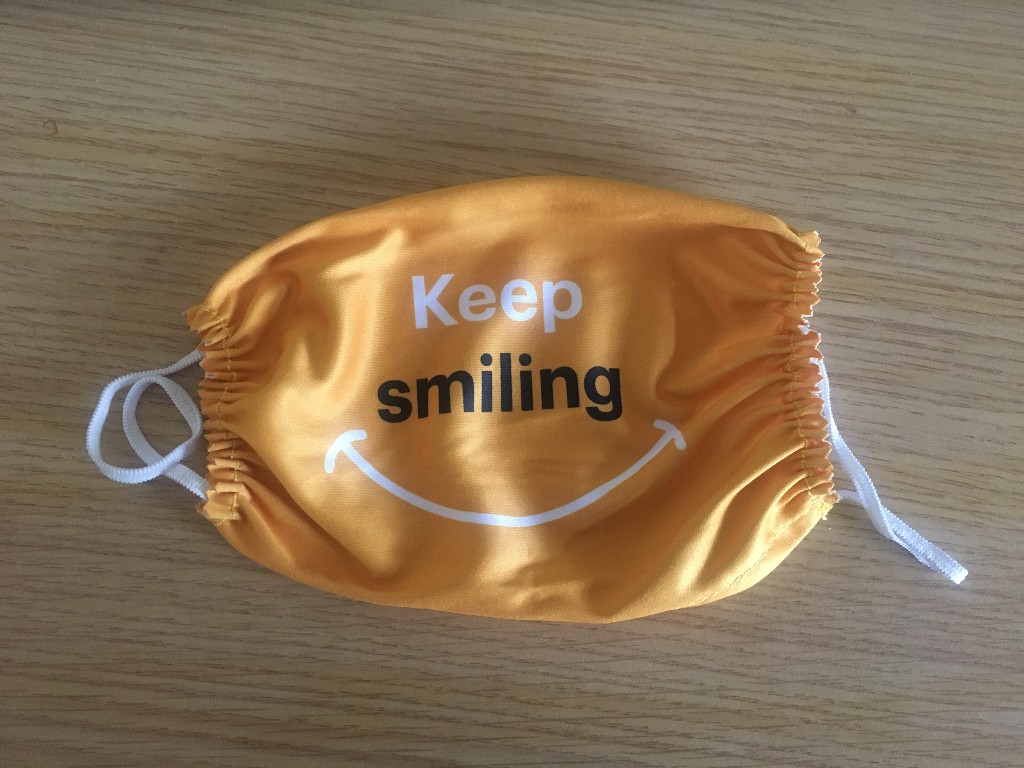 Orange 'keep smiling' face mask