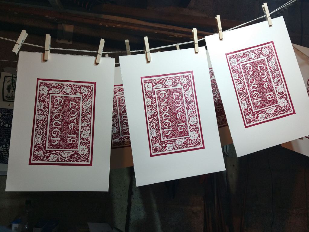 Linocut prints hanging to dry