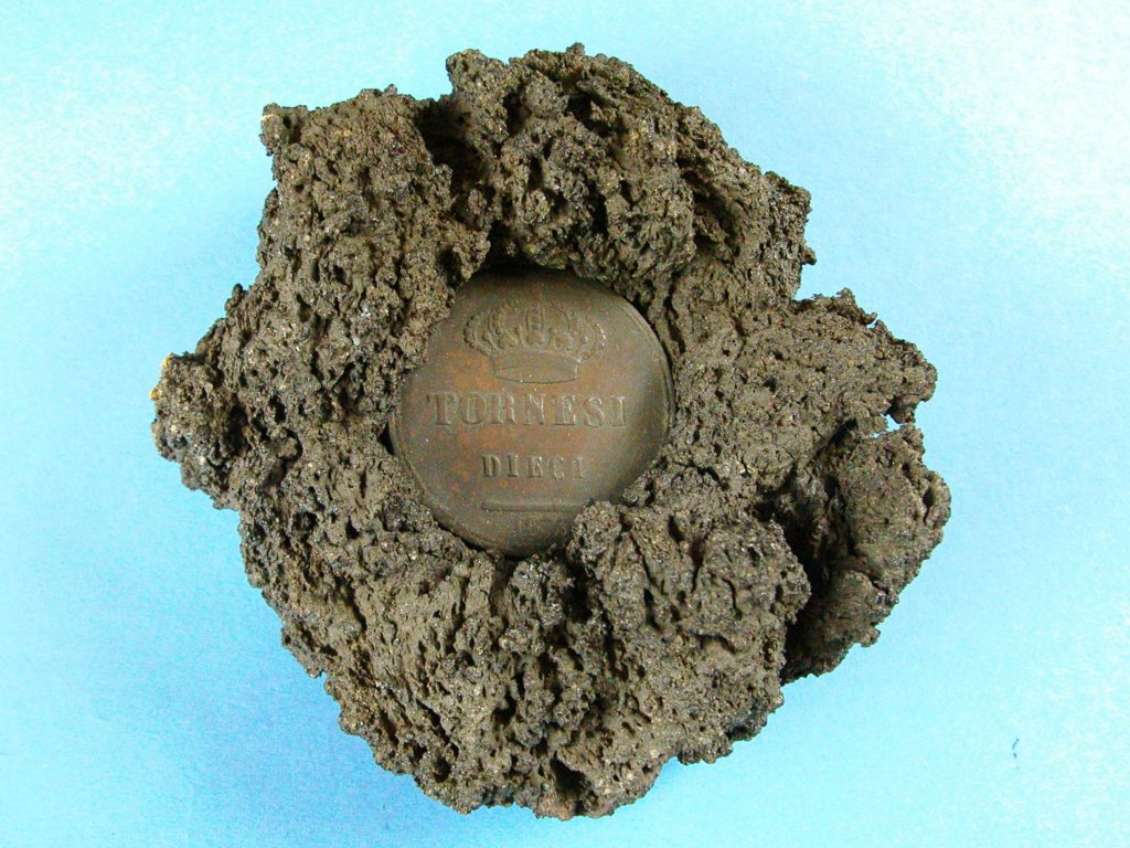 Souvenir coin in volcanic lava