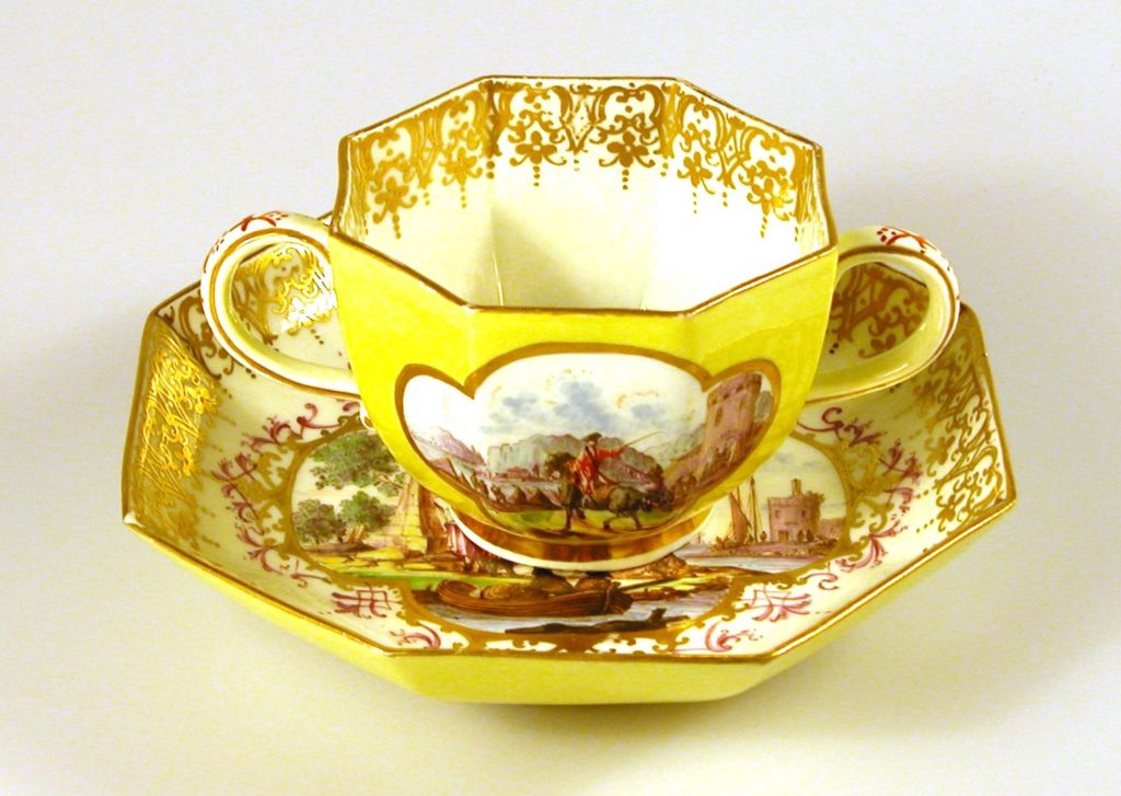 Octagonal cup and saucer with yellow ground and coastal scene 18th century, Meissen