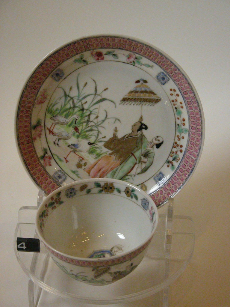 Cup and saucer with figures and birds