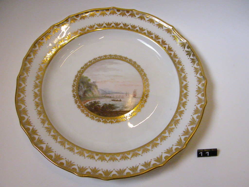 Plate with gilded rim and painted view ‘Near Kinghorn, Fifeshire’ Early 18th century, Derby