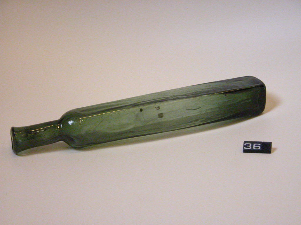 Long dark green glass bottle
