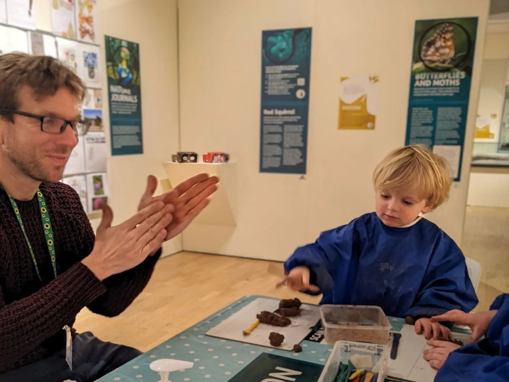 Father and child making clay hedgehogs in the Kent Wildlife exhibition