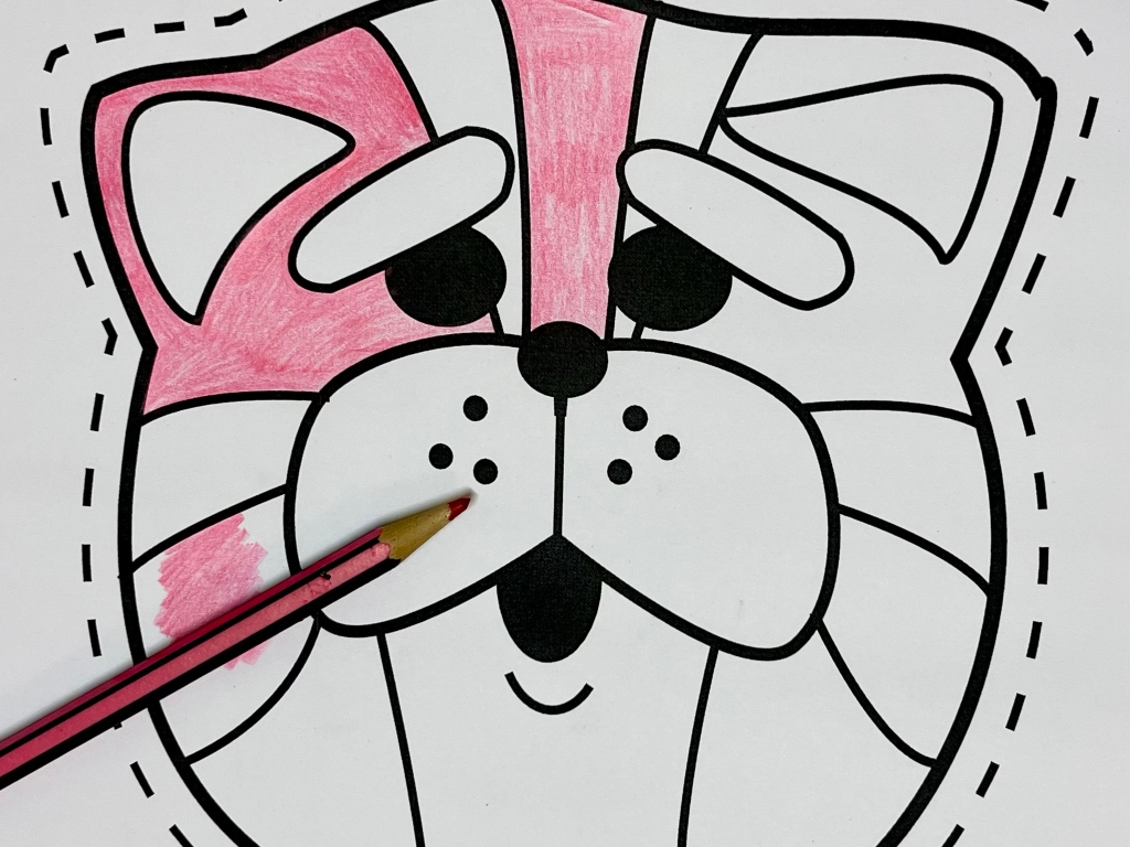 Bagpuss mask half coloured in with a pink pencil left on top