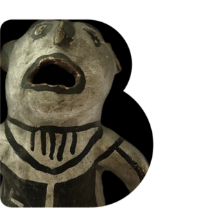B shaped window through which is a grey clay figurine with a wide open mouth and black painted markings